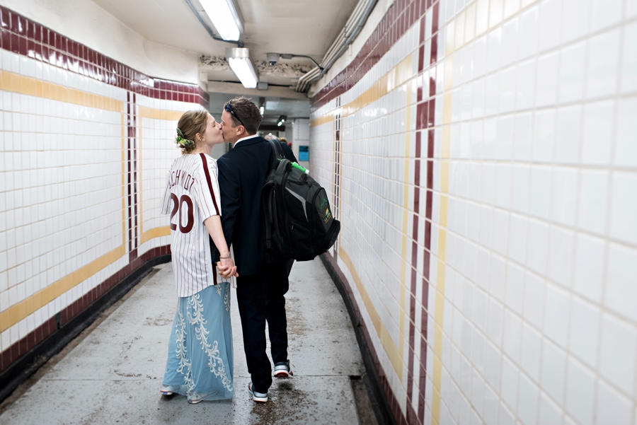 A bride in a Phillies jersey kisses her groom.